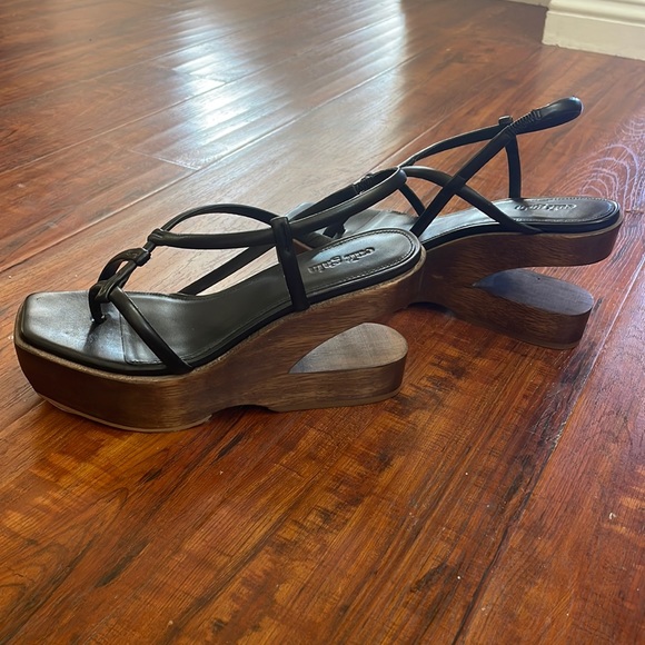 Cult Gaia wooden platform with black cowhide leather.